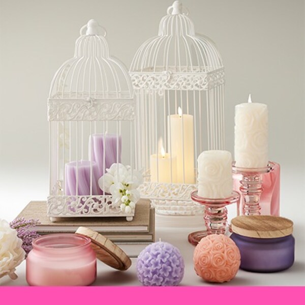 pink and purple candles with white wire lanterns